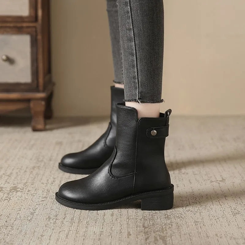 Black women's ankle boots with side zip, round toe, and a low rubber sole.