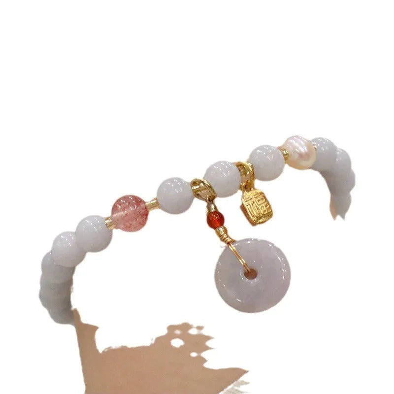 Women's gold plated crystal bracelet with aquamarine chalcedony charm on wrist