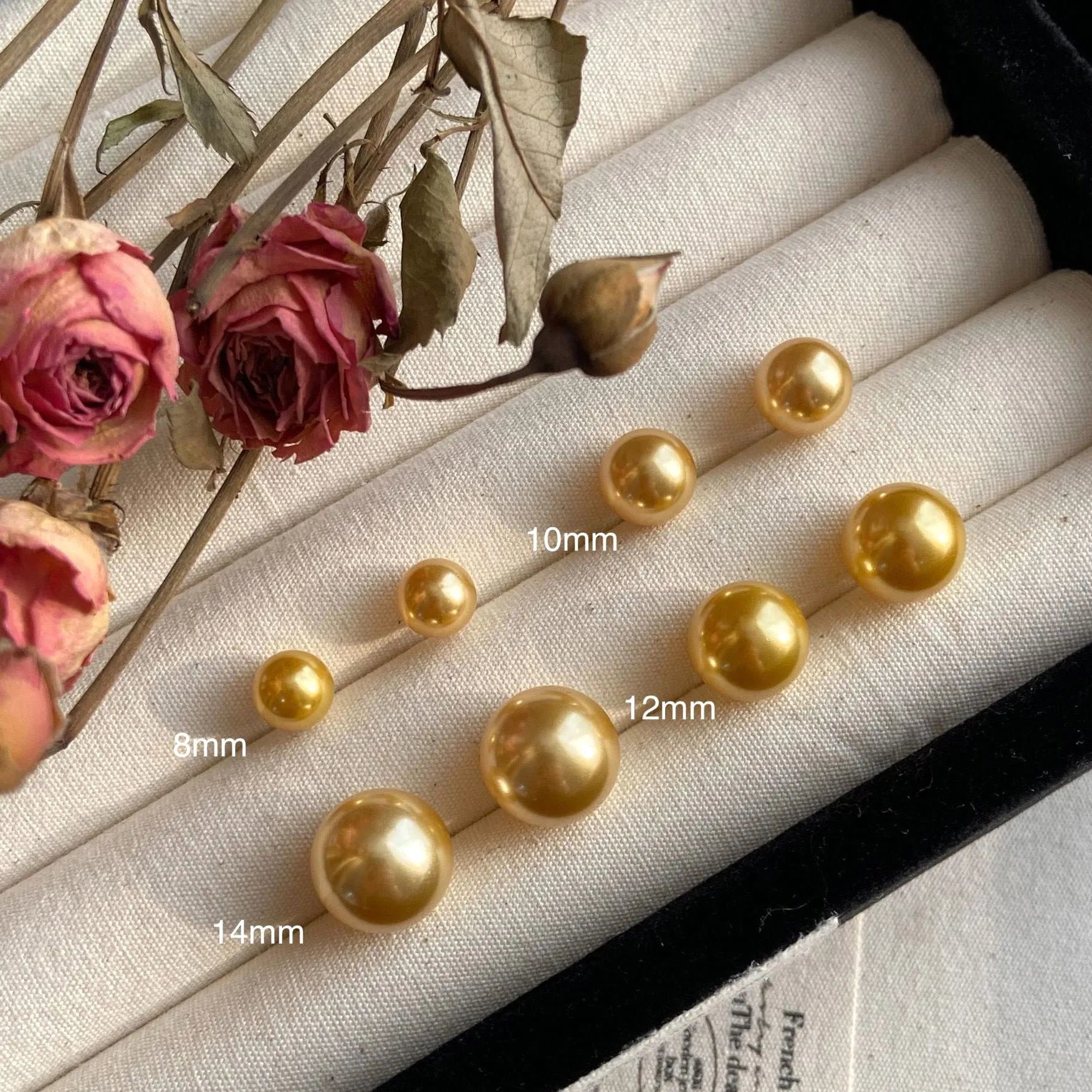 Large pearl stud earrings with geometric eight-point star setting in silver, showing four size options from 8mm to 14mm