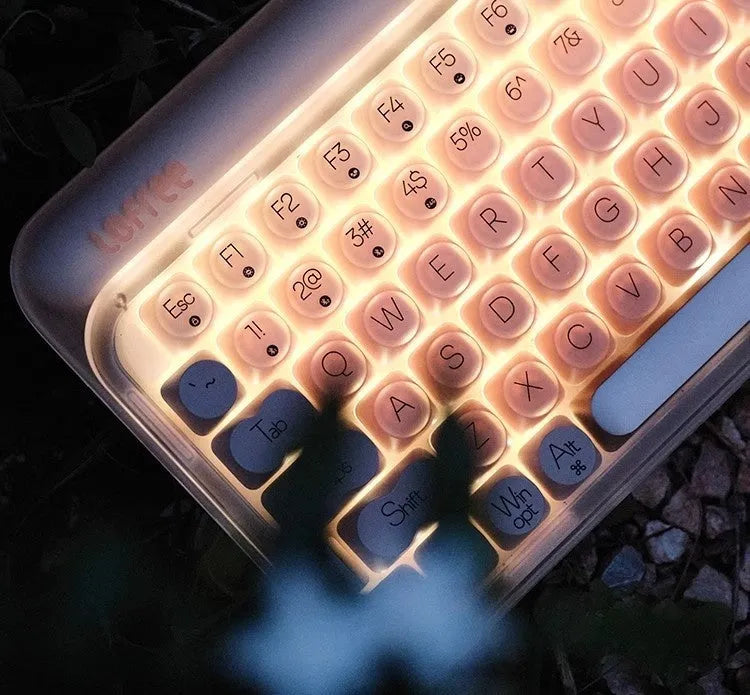 Liquid Foundation 84-key wireless mechanical keyboard with mouse, calculator, and pickup light on office desk