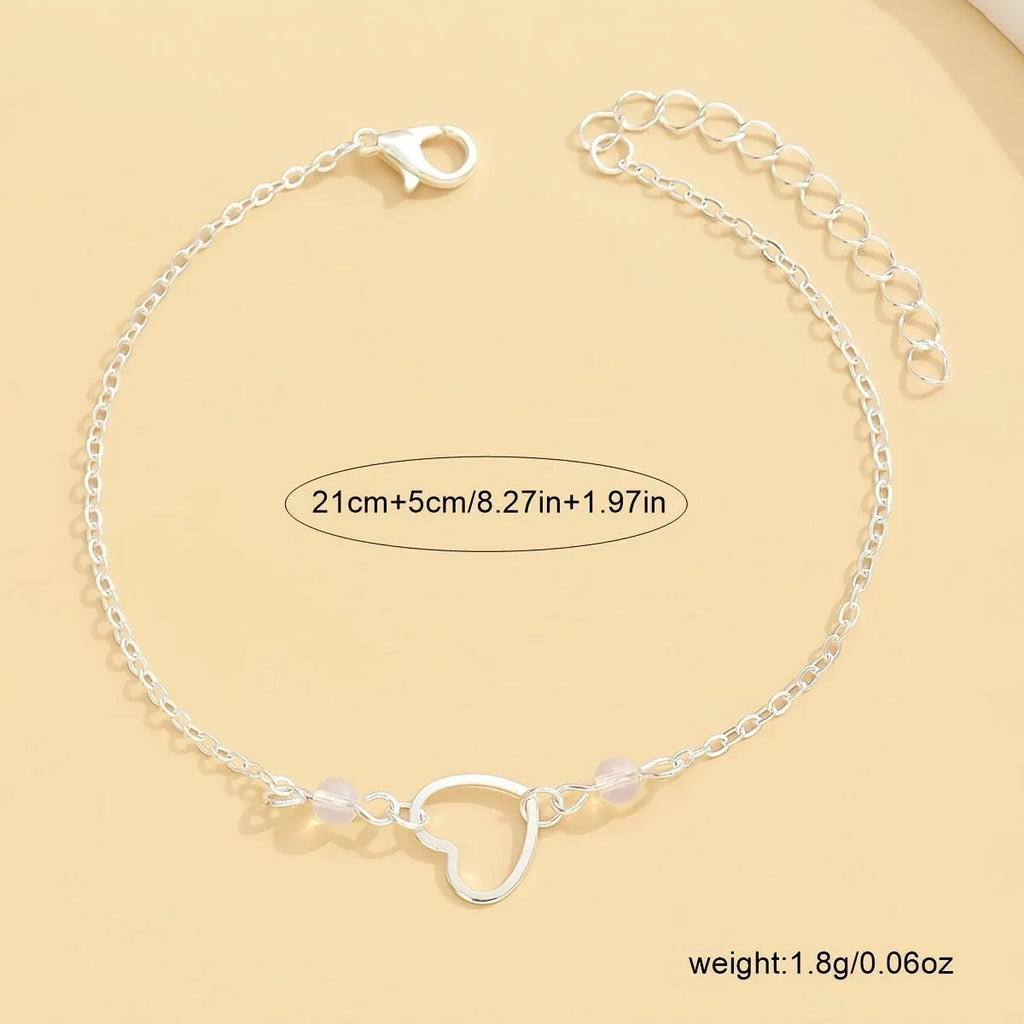Adjustable heart-shaped pendant anklet in gold or silver finish with geometric design