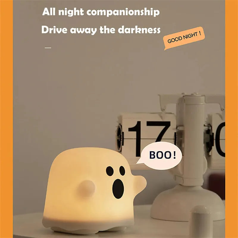 White silicone touch sensor LED night light on a bedside table.