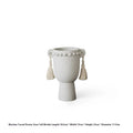 Ceramic binaural planter pot with decorative tassel flower motif on a white background.