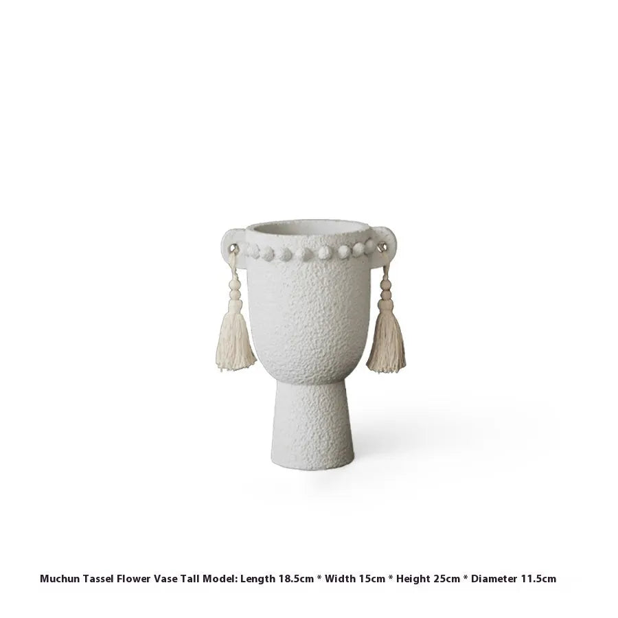 Ceramic binaural planter pot with decorative tassel flower motif on a white background.