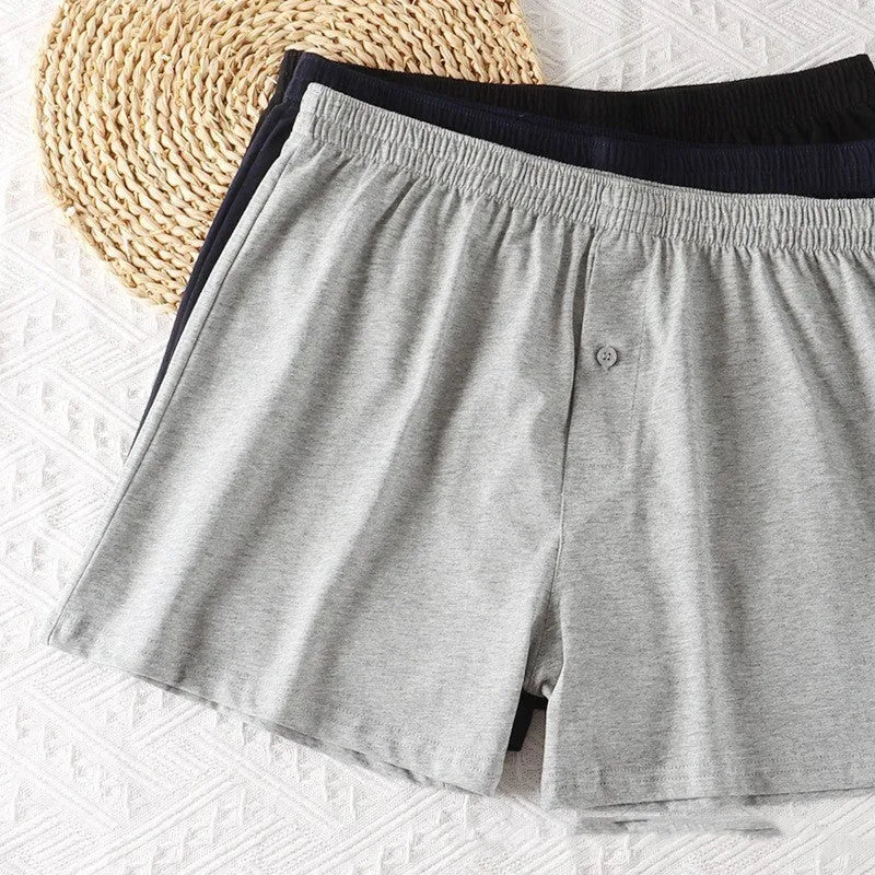 Men's high-waist cotton boxer shorts in light grey, navy blue, and black colours showing knitted fabric texture