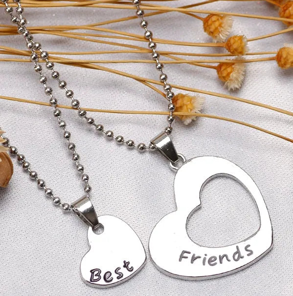 Two-piece silver alloy necklace set with heart-shaped pendants and cross chains in a love design