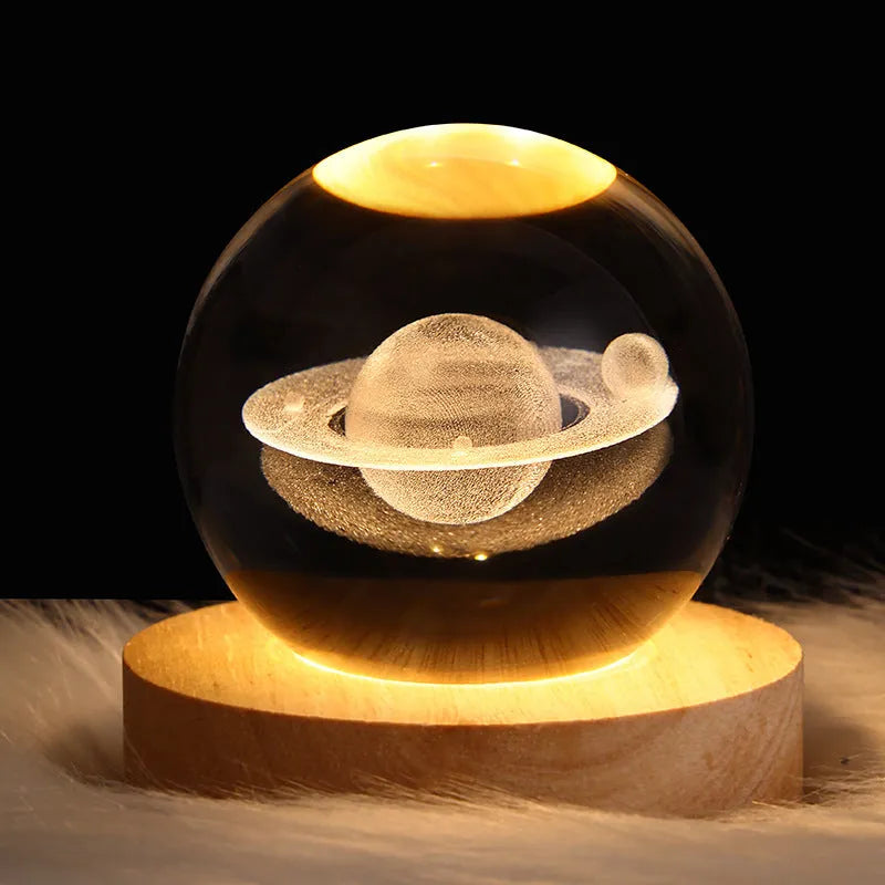 3D crystal ball night light projecting starry sky and planets from its 6cm sphere on a solid wood base.