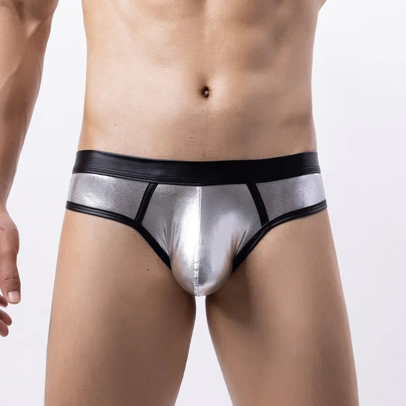 Man modelling gold patent leather look low-waist bikini swim briefs on beach