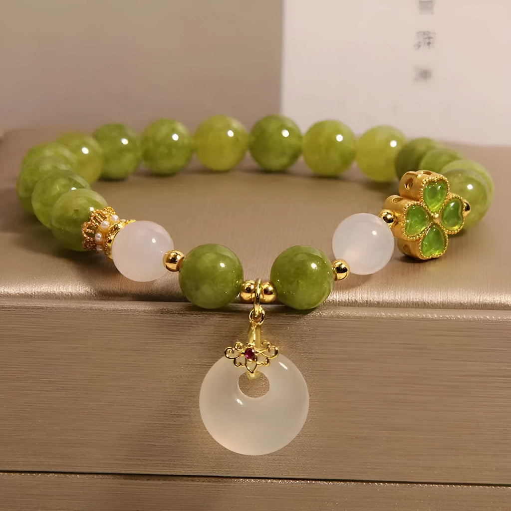 Women's green tourmaline four-leaf clover bracelet with silver electroplated finish and safety buckle clasp.