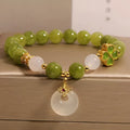 Women's green tourmaline four-leaf clover bracelet with silver electroplated finish and safety buckle clasp.