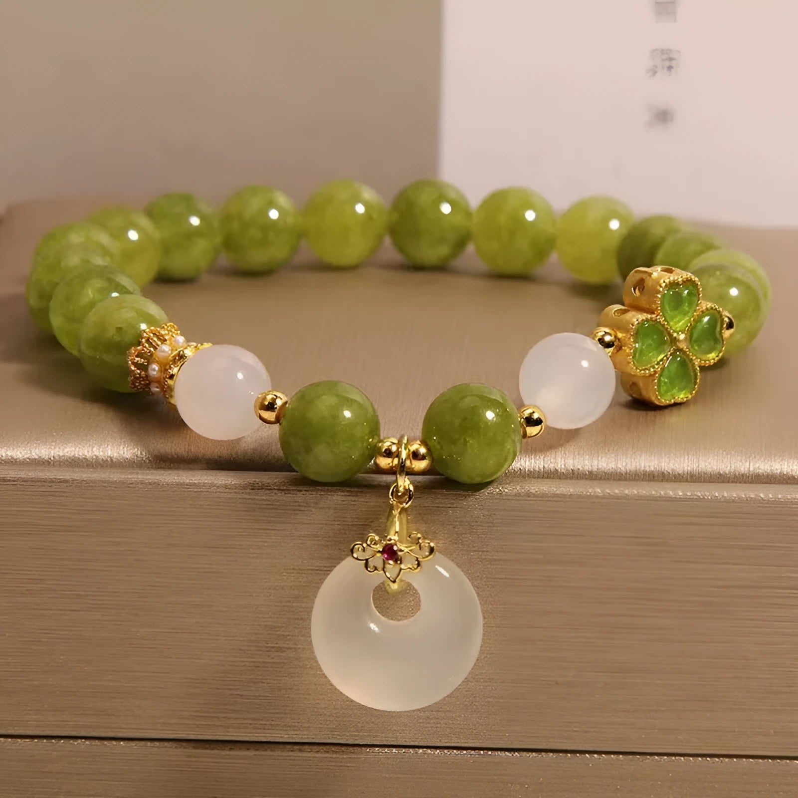 Women's green tourmaline four-leaf clover bracelet with silver electroplated finish and safety buckle clasp.