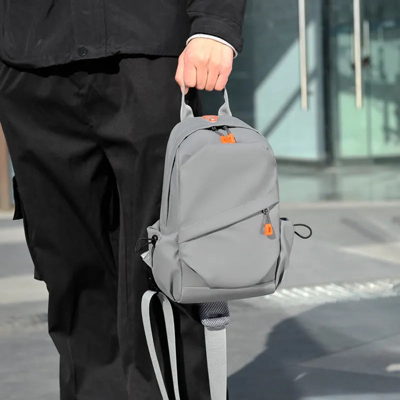 Black mens crossbody bag with adjustable strap showing waterproof polyester material