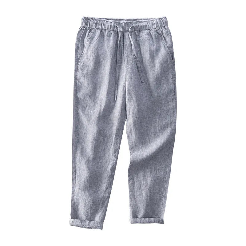 Men's straight-leg linen trousers in dark grey, showing the mid-waist and relaxed leg fit