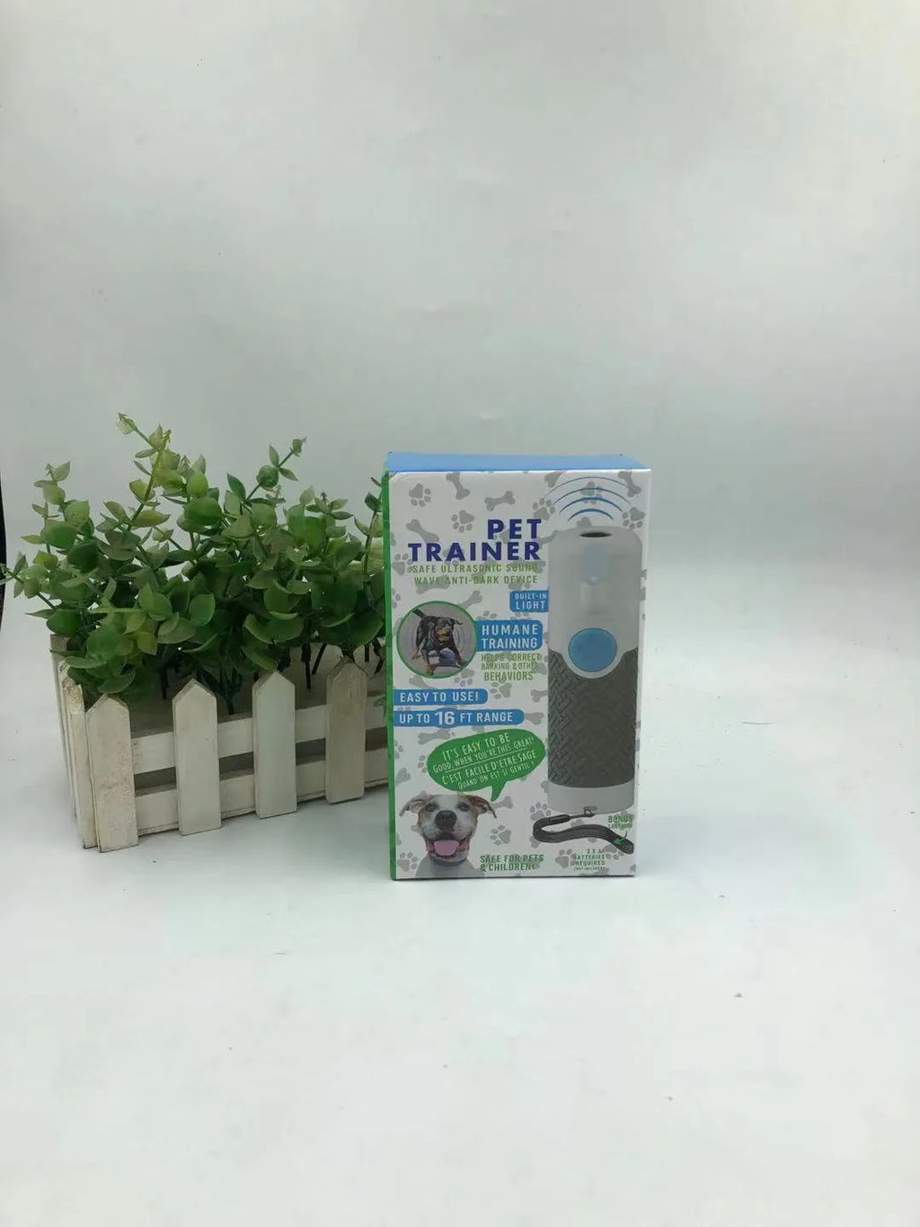 White ABS plastic ultrasonic dog trainer handheld device for bark control with textured grip surfaces
