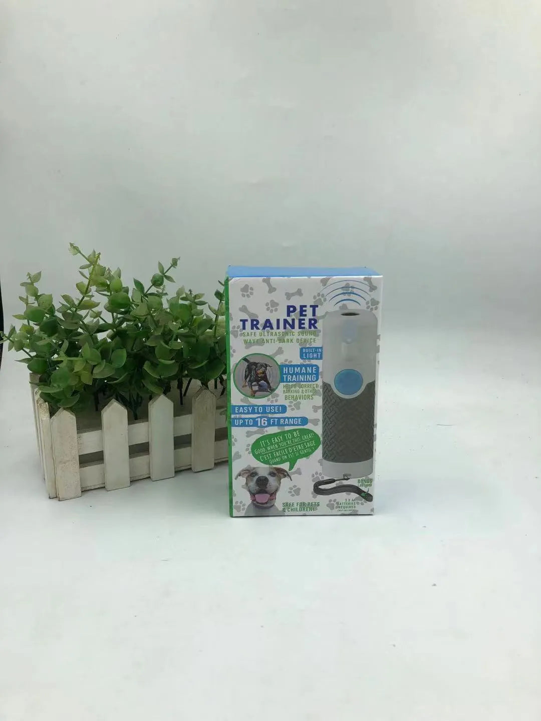 White ABS plastic ultrasonic dog trainer handheld device for bark control with textured grip surfaces