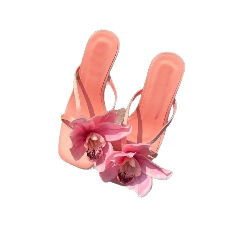 Pink women's high heel sandals with artificial white phalaenopsis flowers on the satin upper