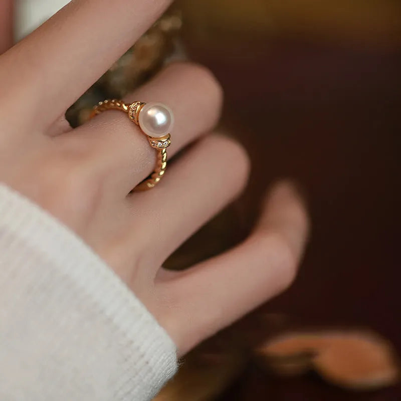 Adjustable copper ring with geometric pearl inlay in antique twist pattern, showing gold and silver finish options