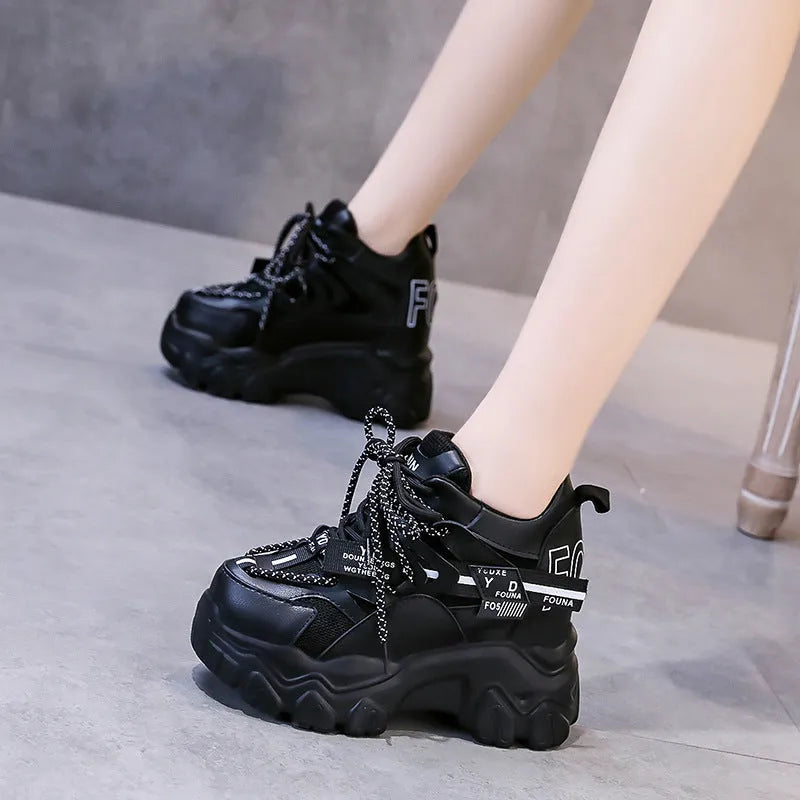 Women's white low-top platform sports shoes with cross strap and rubber sole on a light background