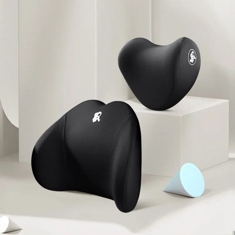 Heart-shaped black and grey car pillow set for headrest and lumbar support on a car seat.