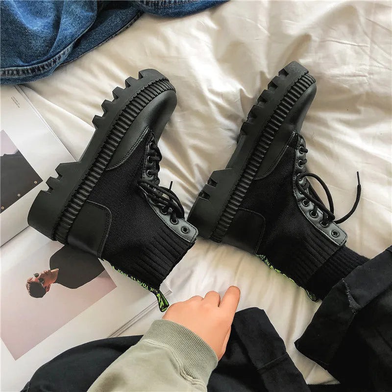 Men's black platform Doc Martens boots with zipper and frosted cowhide, showing 8-hole high-top design and rubber soles.