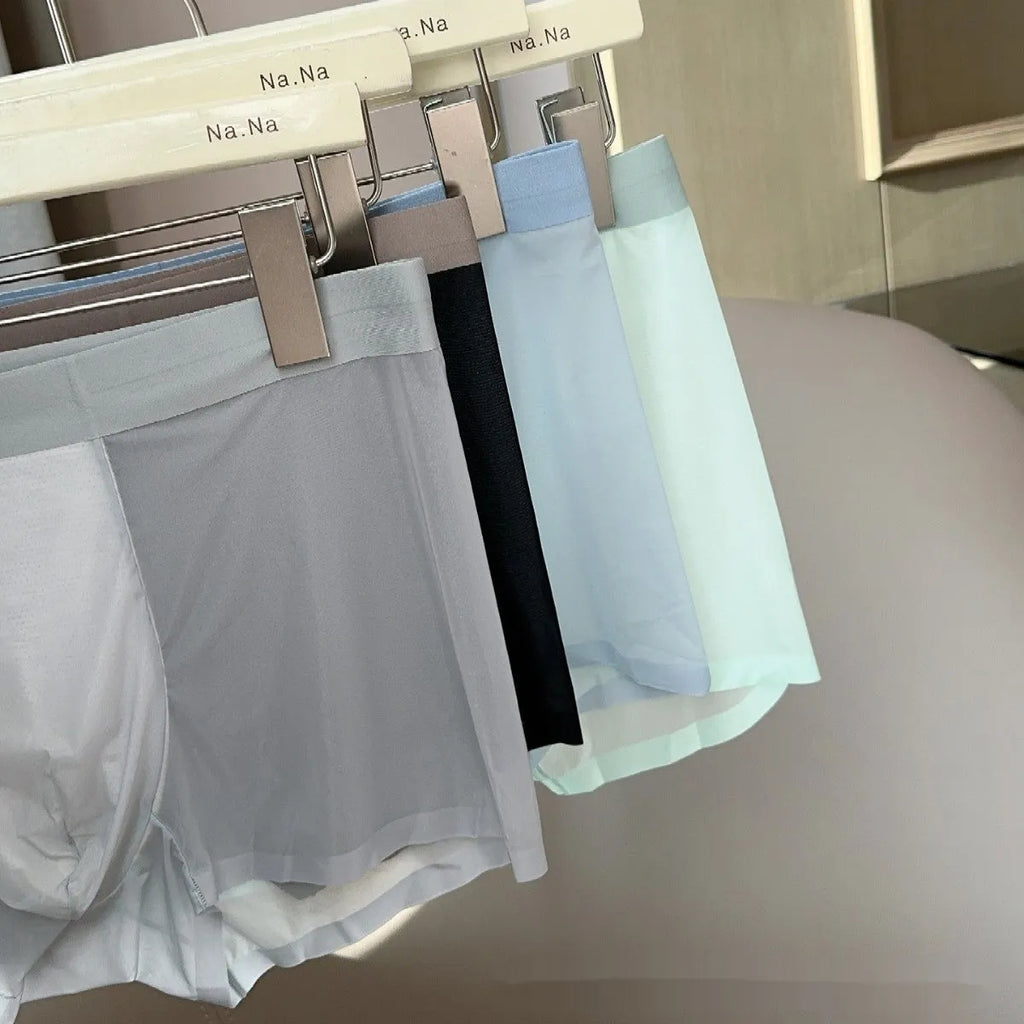 Ultra-thin seamless men's boxers in mid-waist design with honeycomb crotch, available in multiple colours like black and bright red.