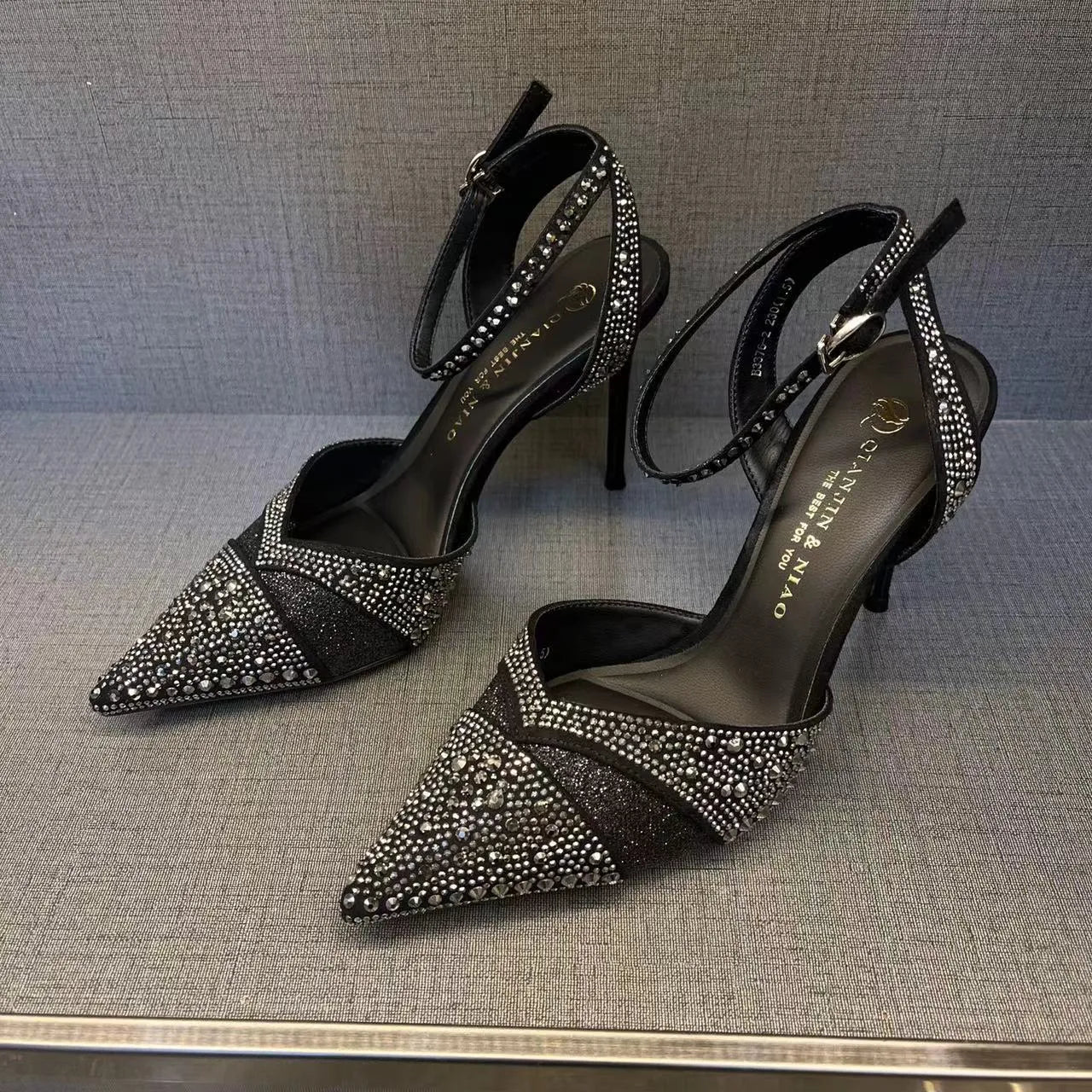 Women's hollow high heels with stiletto heel, pointed toe, and red sole in silver and black colours