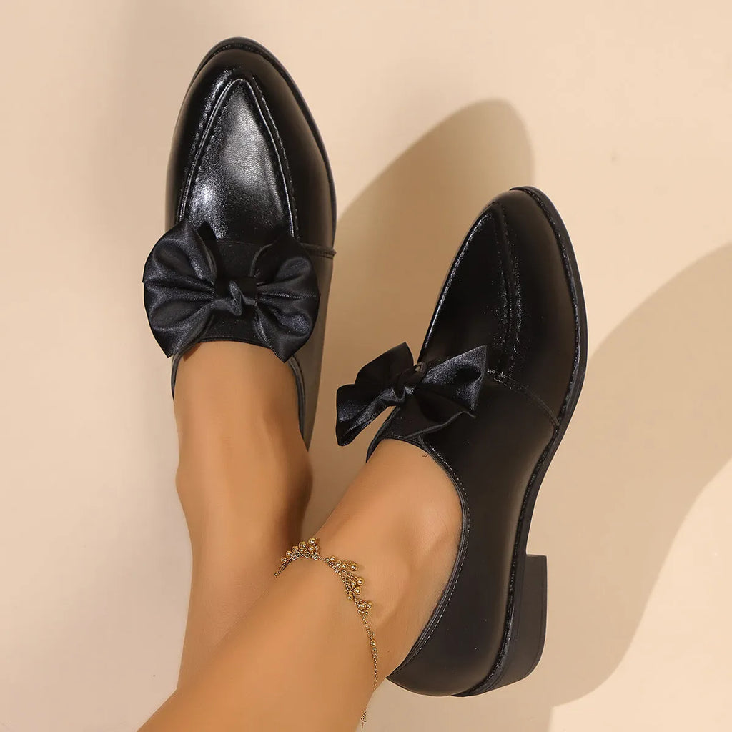 Women's British-style simple leather shoes with bow detailing, PU upper, and rubber sole in available sizes.