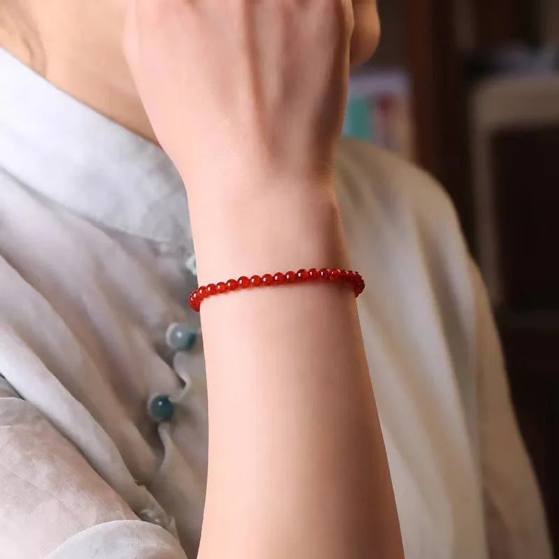 A red agate bracelet for women with an ultra-thin, delicate design on a wrist.
