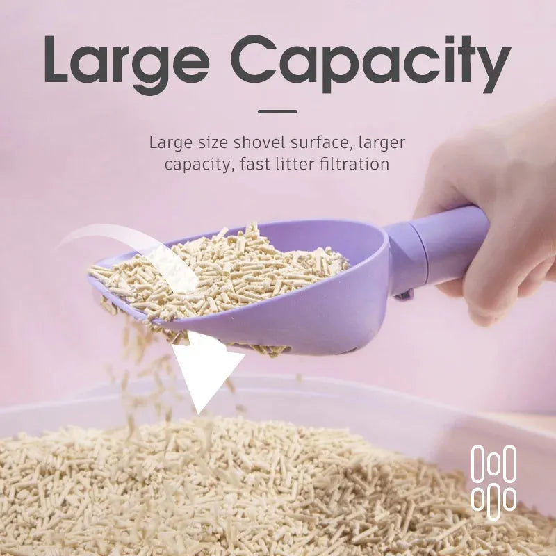 White ABS plastic cat litter scoop standing on a matching storage base with integrated waste bag roll.