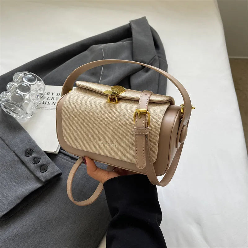 Women's PU leather messenger bag in horizontal square shape with contrast stitching and lock fastening
