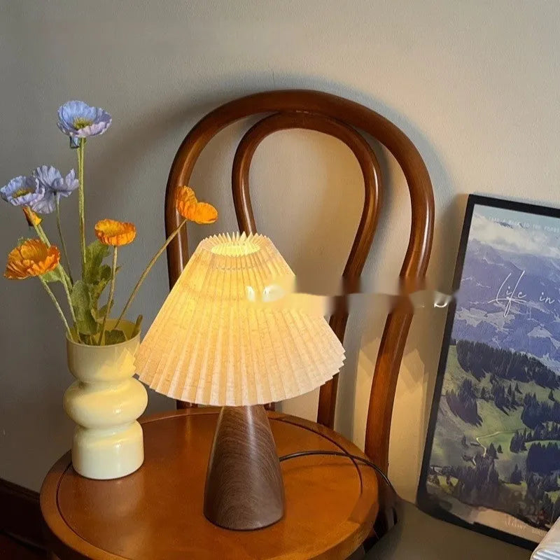 Nordic retro ceramic bedside table lamp with a pleated tapered floral fabric shade on a ceramic base.