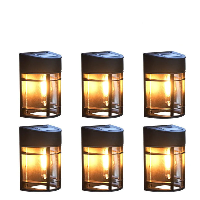 Tungsten-style solar-powered outdoor wall light with automatic light sensor mounted on a garden wall.