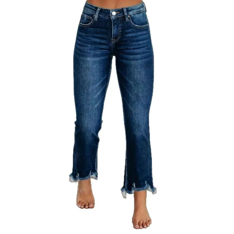 Women's hand-worn denim trousers in dark blue, showing 100% cotton fabric and casual fit