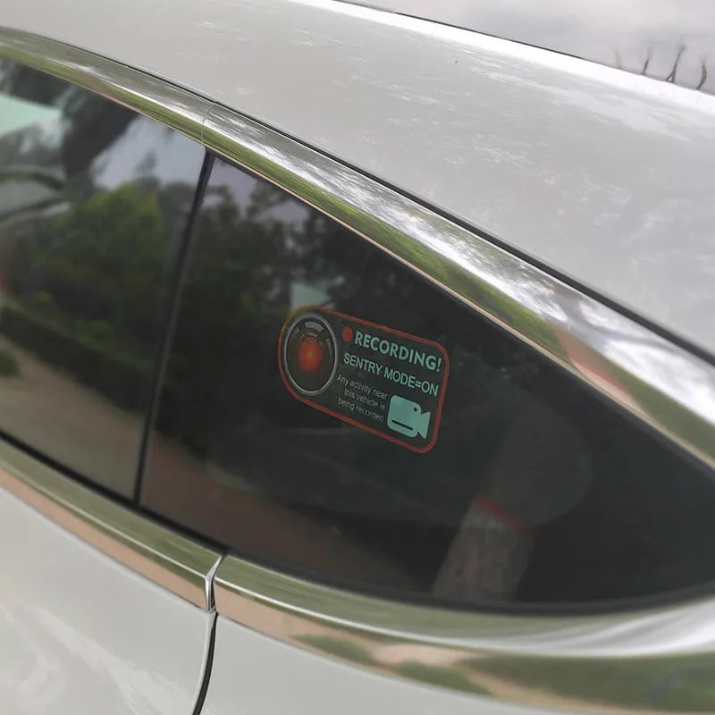 Tesla Sentry Mode electrostatic warning sticker measuring 11 by 5 centimetres