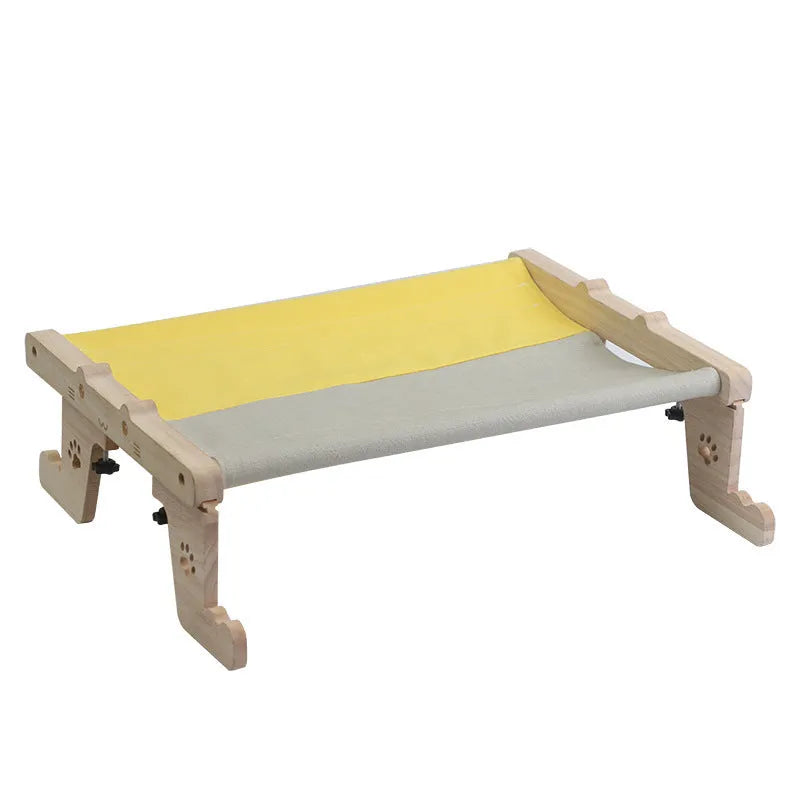 Wooden framed cat hammock bed hanging by a window, suitable for cats and small dogs.