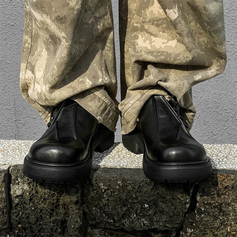 Black low-top platform leather shoes with round toe and rubber sole.