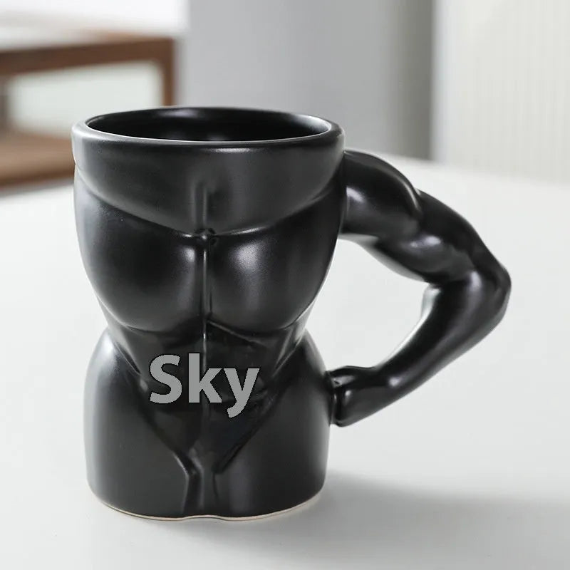 Matte black ceramic mug with muscle man design and 300ml capacity.