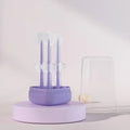 Purple soft silicone toothbrush for cleaning cat and dog teeth on a white background.