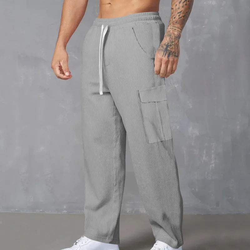 Men's straight-leg corduroy cargo trousers in navy blue with drawstring waist, suitable for casual autumn wear.