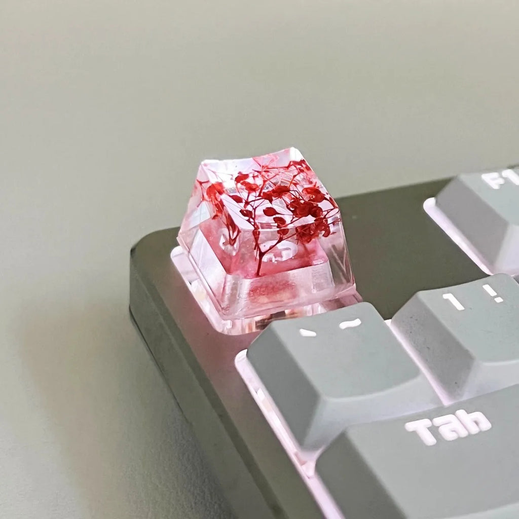 Translucent resin starry sky keycap with glitter particles measuring 1.8cm by 1.2cm