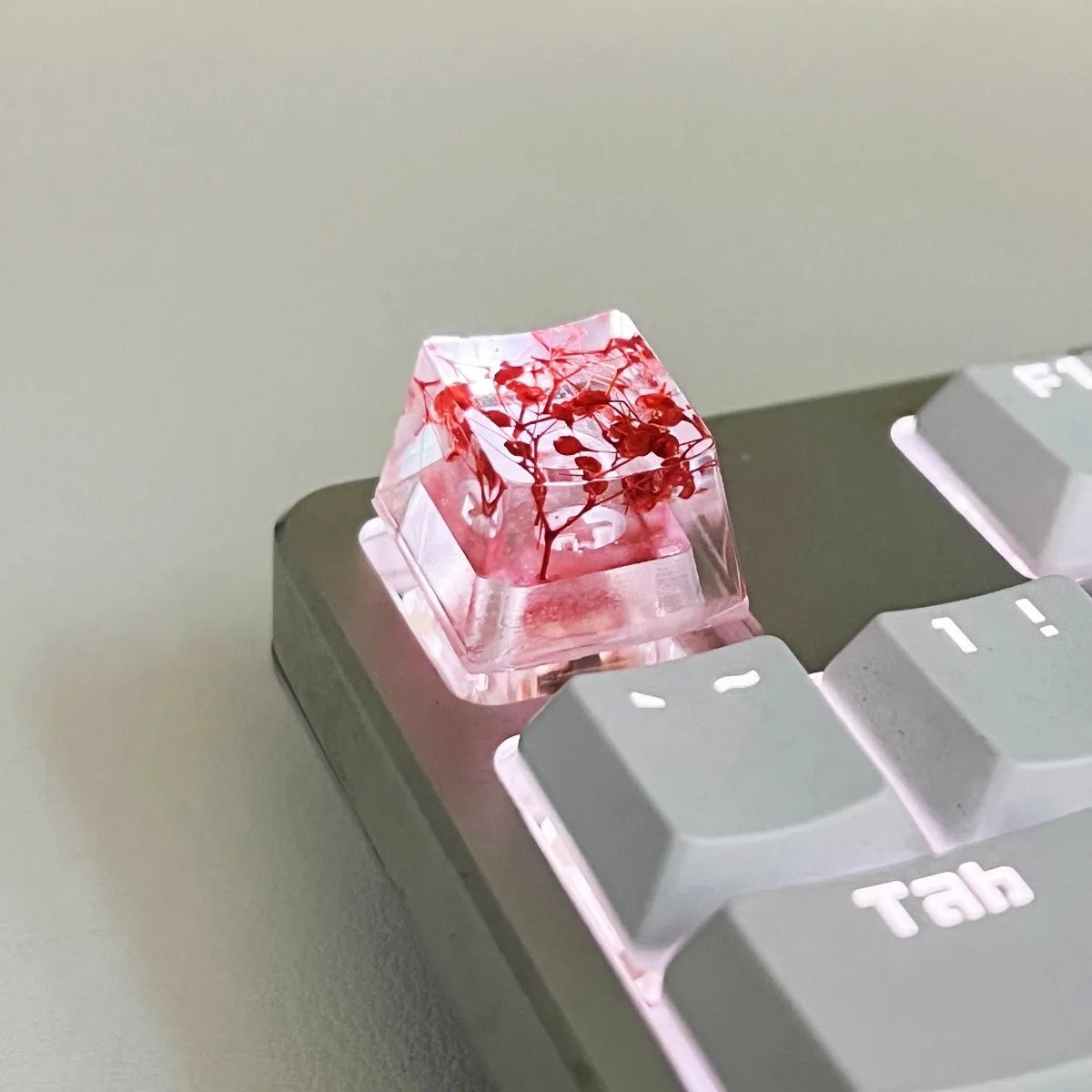 Translucent resin starry sky keycap with glitter particles measuring 1.8cm by 1.2cm