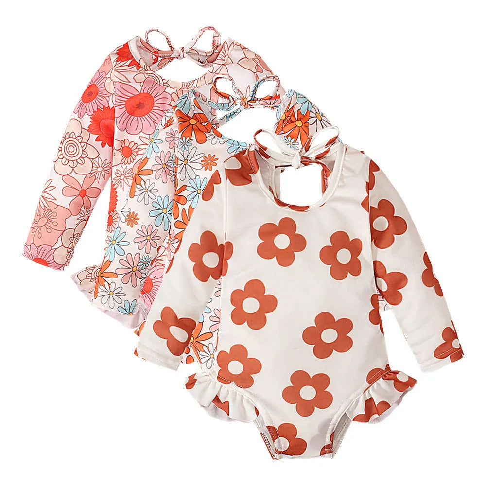 Girl's floral pattern open back swimsuit in polyester fabric showing crew neck design