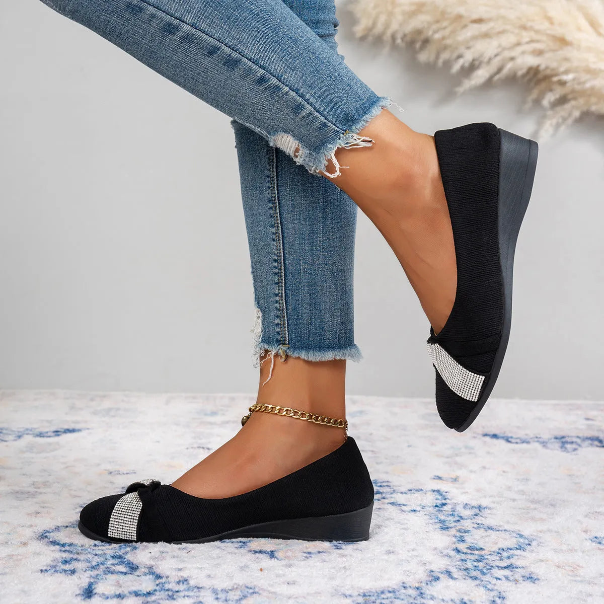 Women's black casual slip-on shoes with rhinestone details and a chunky heel on a white background.