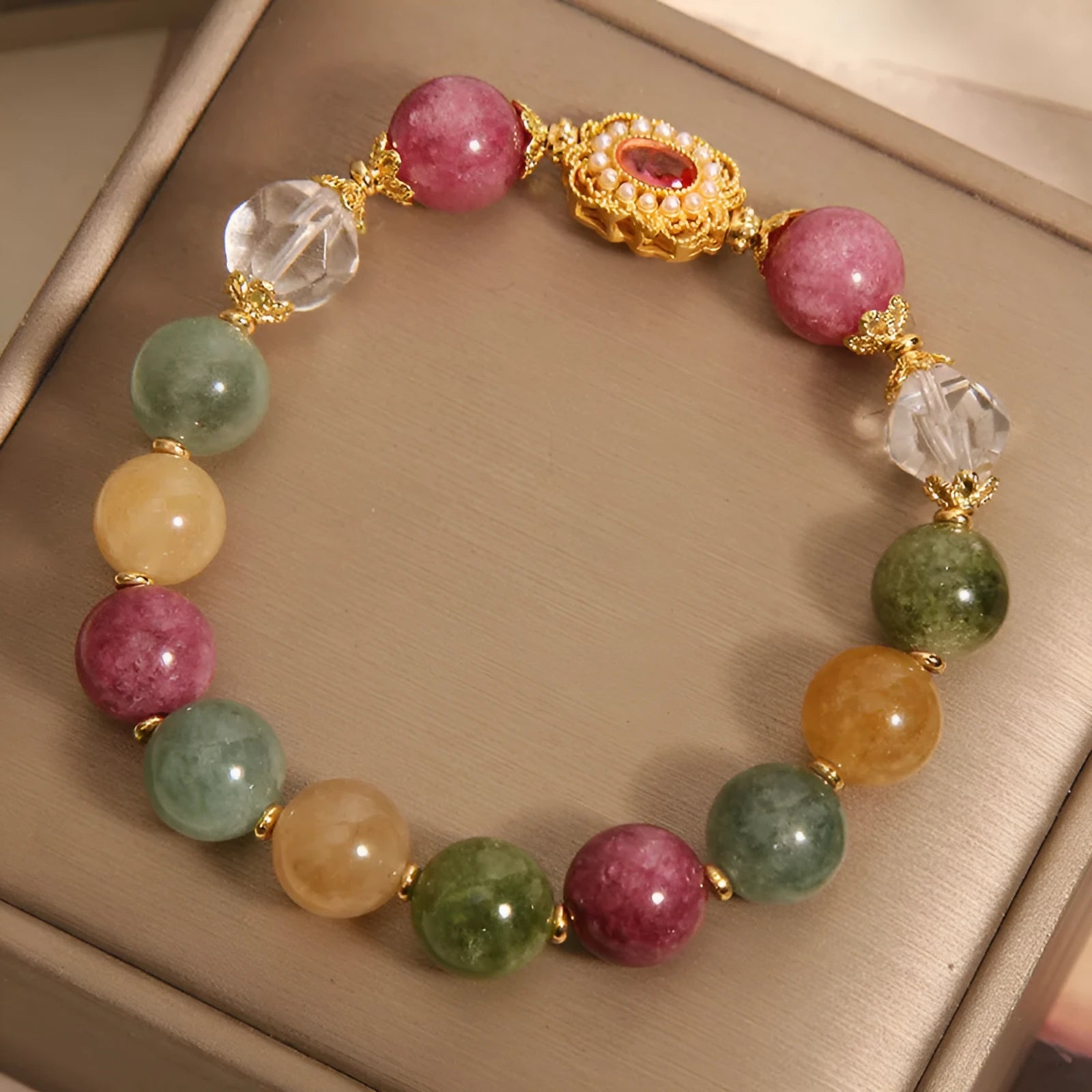 Jade colour tourmaline bracelet for women with alloy setting and rhinestone details on pearl crystal base.