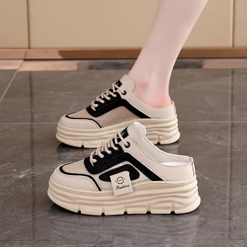 Women's black mesh half slippers with a round toe and rubber sole on a white background.
