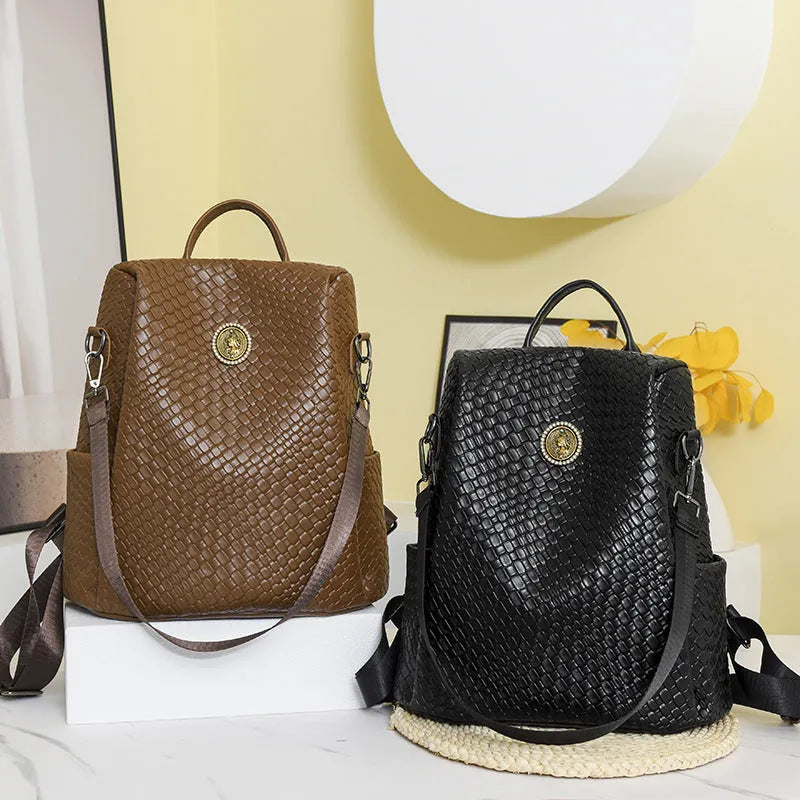 Women's black waterproof anti-theft backpack showing woven detailing and organisational compartments