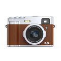 Black 5K HD digital camera with dual lenses, optical viewfinder, and 2.88-inch display screen on a table