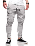 Men's loose-fit polyester trousers with elastic waistband and patch pockets in army green colour