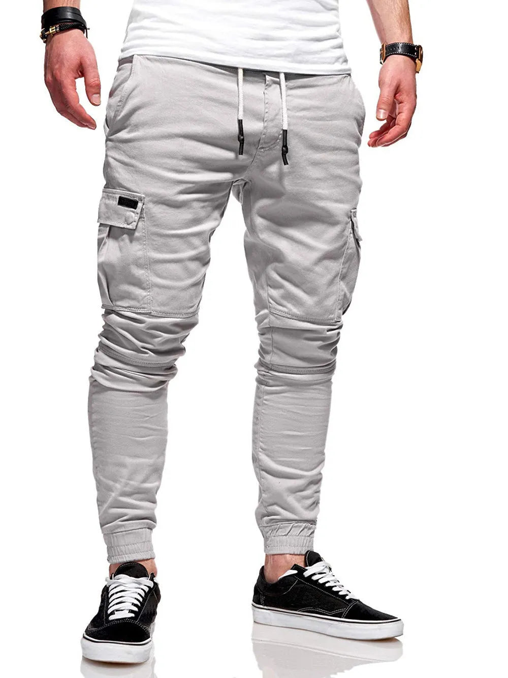 Men's loose-fit polyester trousers with elastic waistband and patch pockets in army green colour
