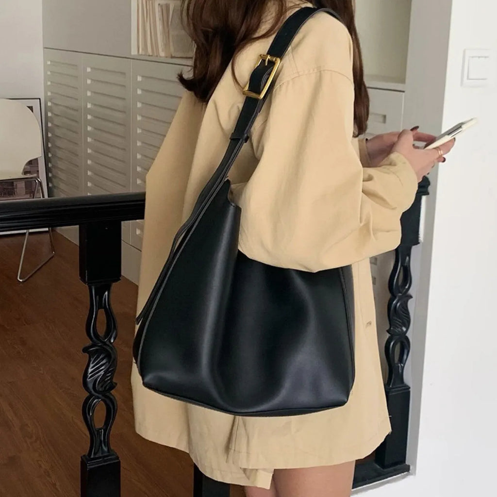 Two soft PU women's shoulder bags with swing threads decoration, shown in black and brown colour options.